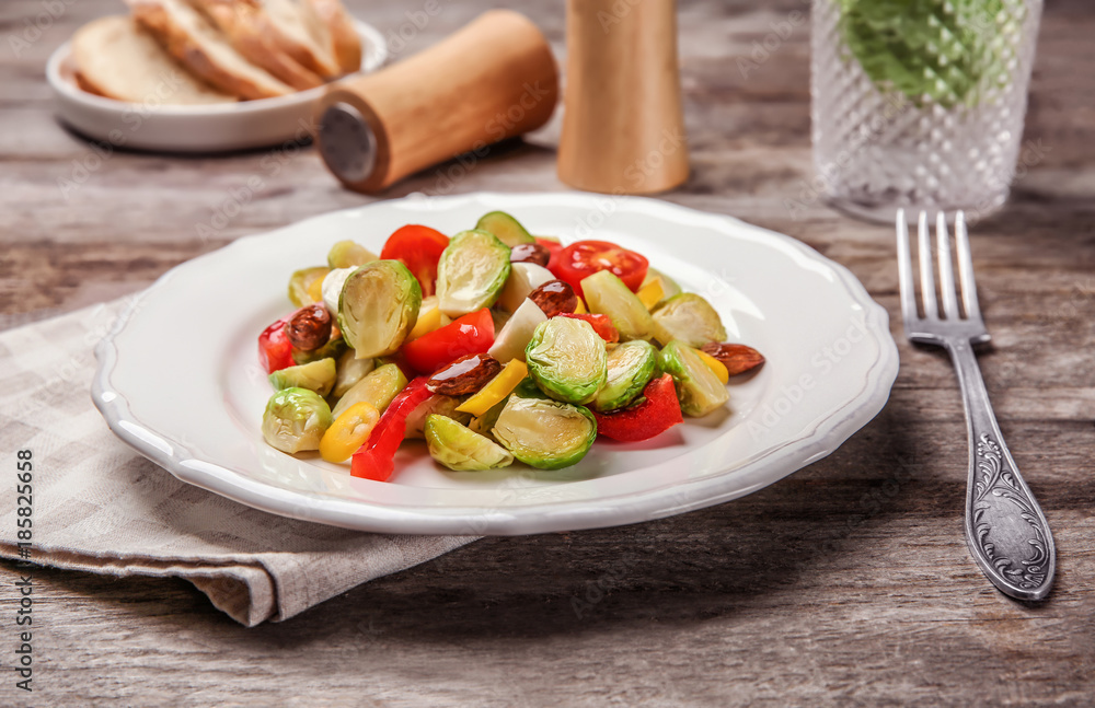 Plate of salad with Brussels sprouts on table