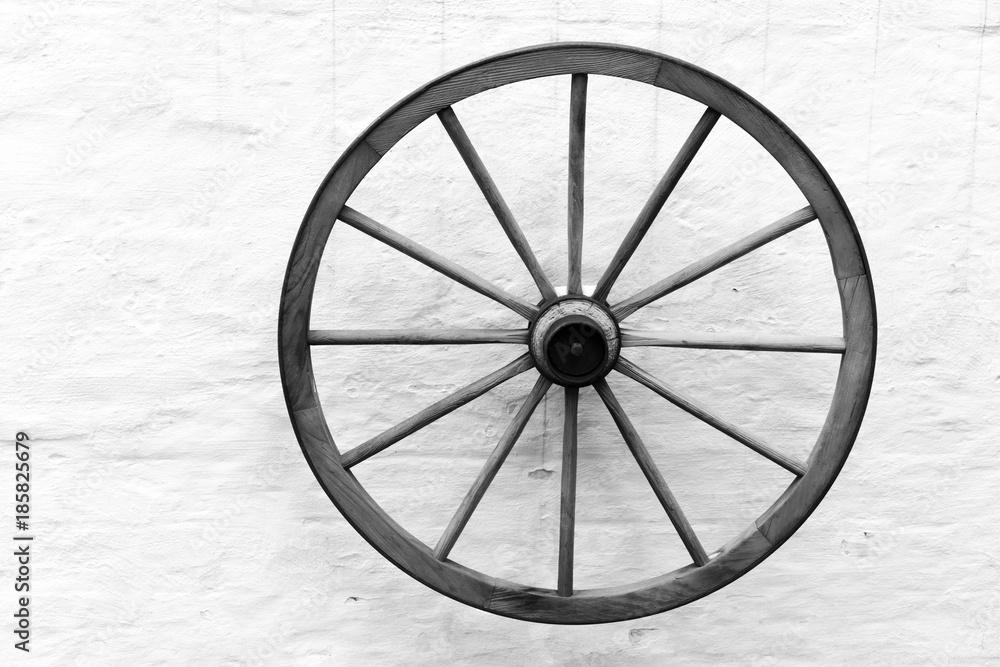 Old wooden cart wheel on the wall