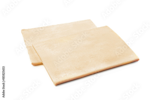 Raw puff pastry on white background