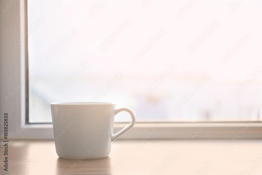 Ceramic cup on window sill Ceramic cup on window sill