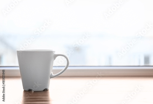 Ceramic cup on window sill