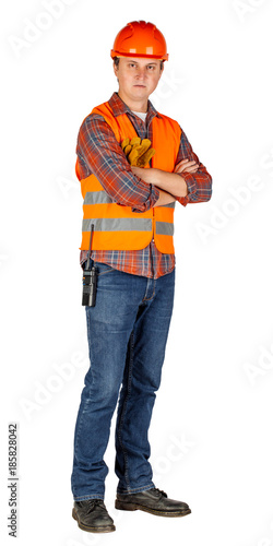 Full length portrait of a male builder in a orange helmet over white wall background. repair, construction, building, people and maintenance concept..