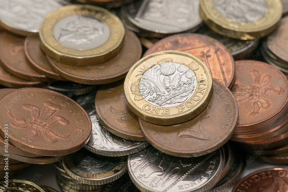 Close up focus photos of new United kingdom Pound coin, among other British coins Close up focus photos of new United kingdom Pound coin, among other British coins