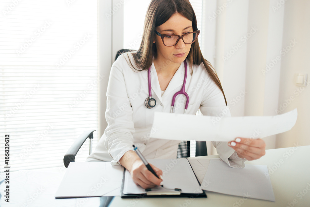 Young female doctor at office desk Young female doctor at office desk