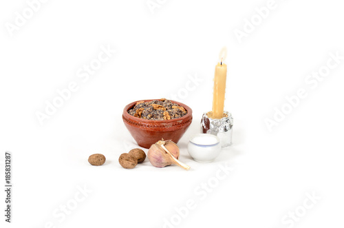 Traditional Christmas treat of the Slavs on Christmas eve. Slavic food kutia, garlic, candle on white background