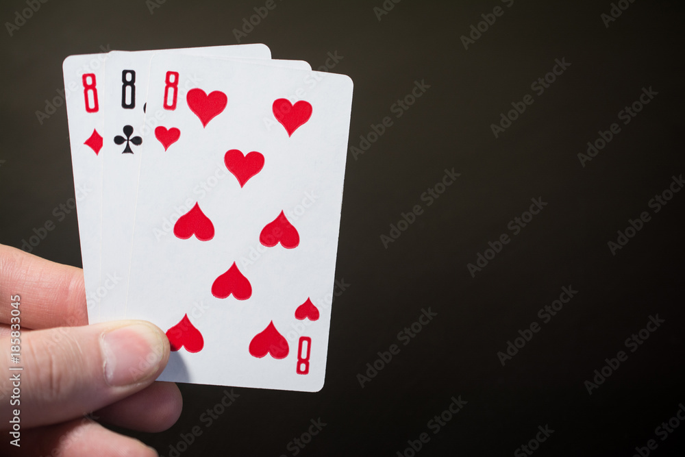 Abstract: man hand holding playing card three eight isolated on black background with copyspace poker set four eight Abstract: man hand holding playing card three eight isolated on black background with copyspace poker set four eight