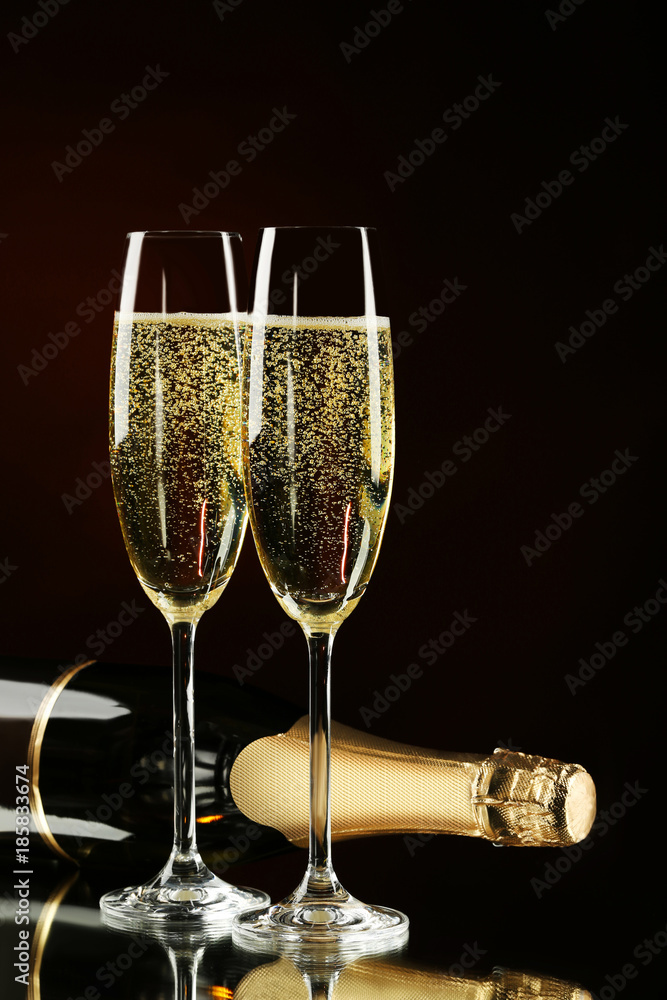 Champagne bottle with glasses on black background Stock Photo | Adobe Stock
