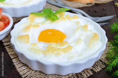 Delicate baked egg Orsini (eggs in the cloud). French breakfast.