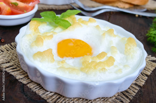 Delicate baked egg Orsini (eggs in the cloud). French breakfast.