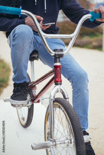 Male bicycle rider on street with phone