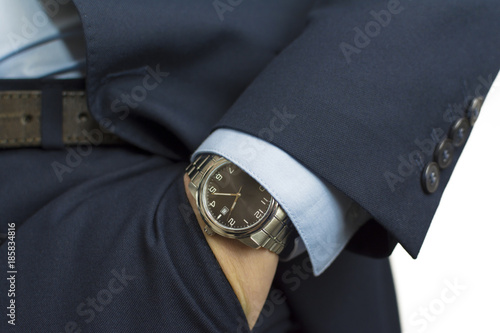 Hand in pocket with wrist watch in a business suit close up