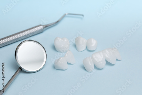 Dental tools and dentures on a light blue background