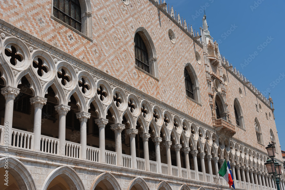 Part of the facade of Doge's Palace (Palazzo Ducale) in Venice during the day show the detailed gothic style architecture