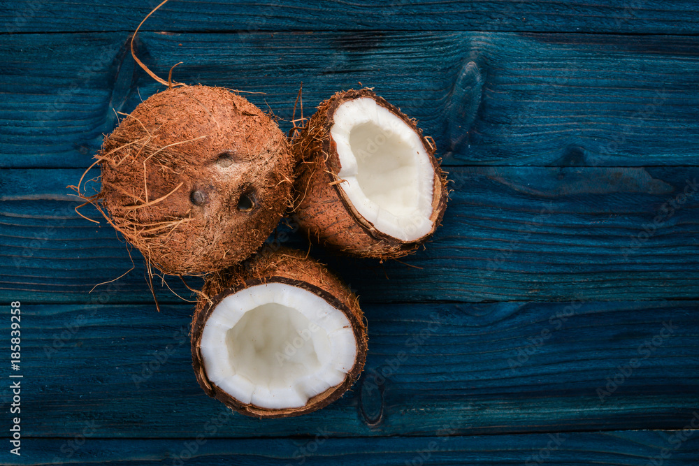 Coconut on a wooden background. Tropical fruits and nuts. Top view. Free space for text. Coconut on a wooden background. Tropical fruits and nuts. Top view. Free space for text.