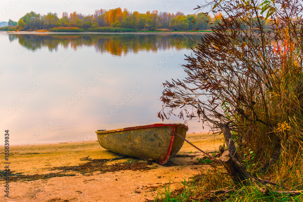 Old boat on the river bank in autumn time. Dnieper river. Ukraine. Old boat on the river bank in autumn time. Dnieper river. Ukraine.