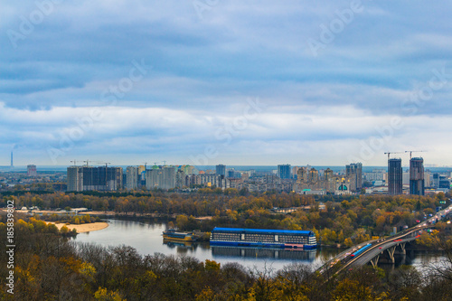 Panorama of Kyiv from the Park of Glory. Metro bridge across the Dnipro river. Autumn evening.