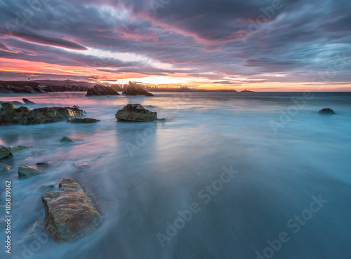 spectacular and colorful sunset on the beach of Arnao