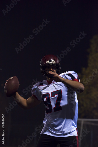american football player throwing rugby ball