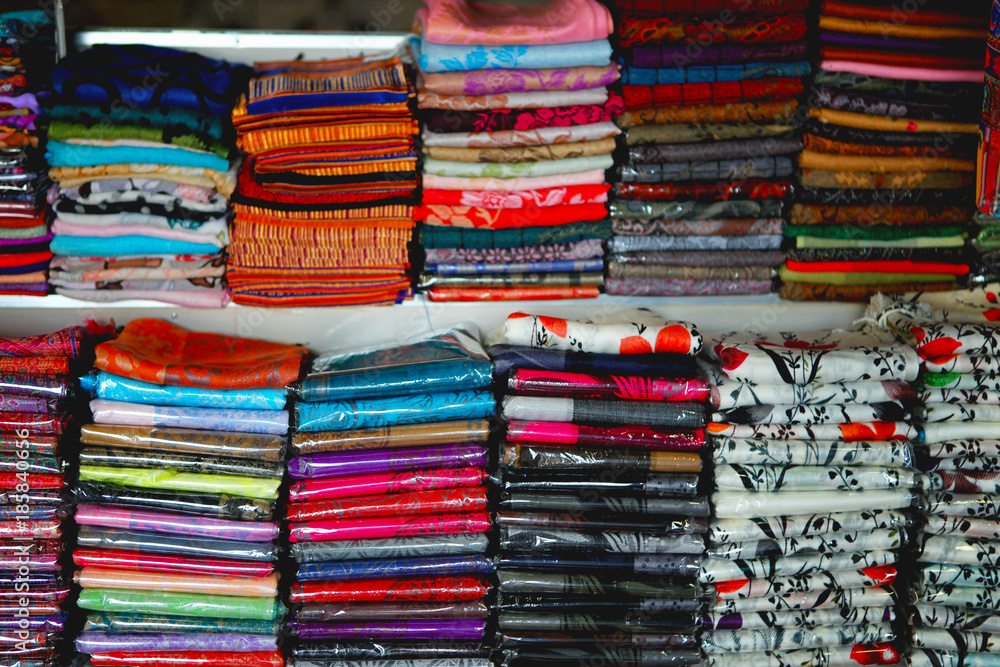 Fototapeta premium beautiful and colourful silk and cotton Indian scarfs sold in souvenir shop market stall