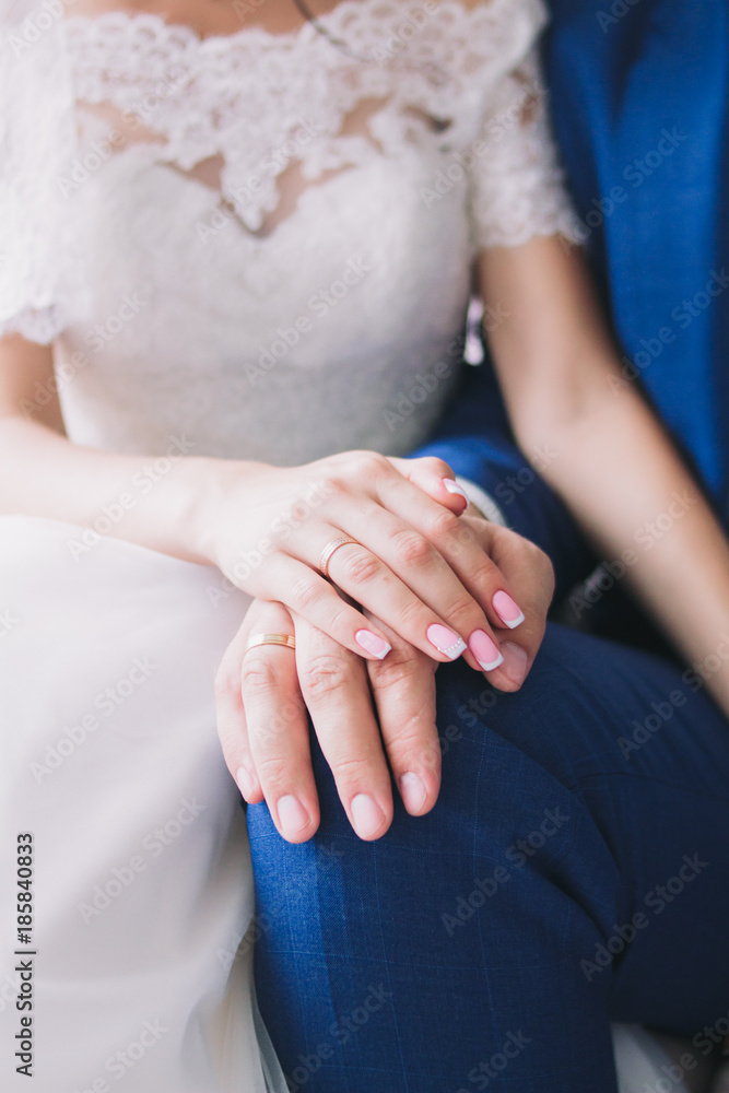 Close-up of the hands of the bride and groom in wedding rings