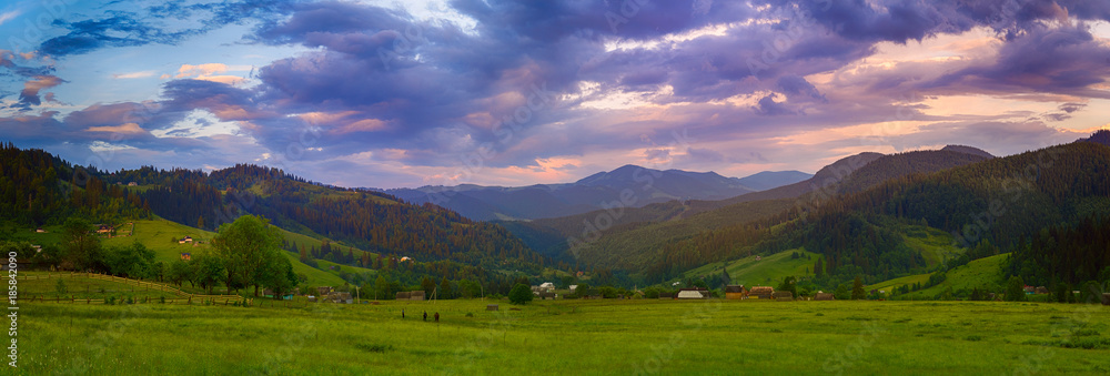 Carpathian mountains summer landscape with cloudy colorful sky and village at sunset, natural travel background - obrazy, fototapety, plakaty 