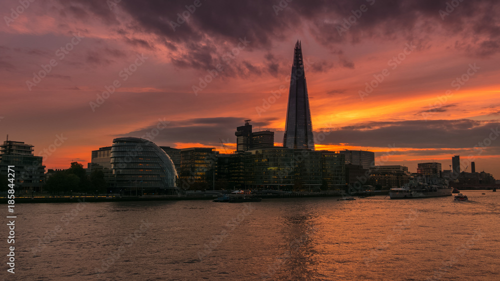 Wide early evening shot of the River Thames, the Shard and City Hall in London, England, UK