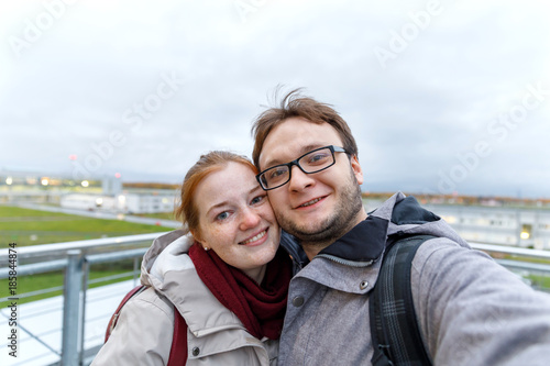 Travelling young couple take the selfie shot, smiling and happy, in the sport style clothes and backpack
