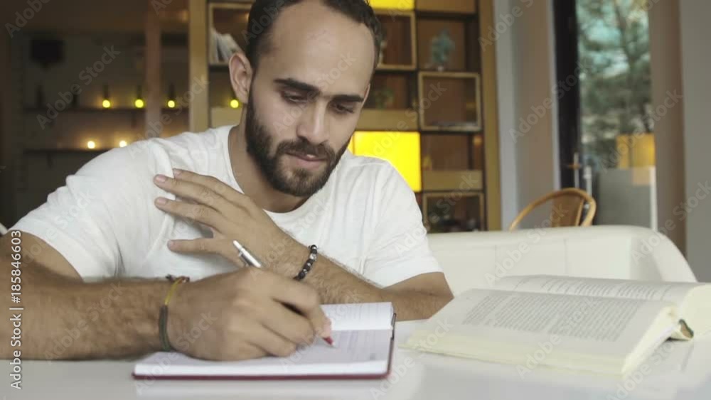 Student studying writing in notebook Student studying writing in notebook