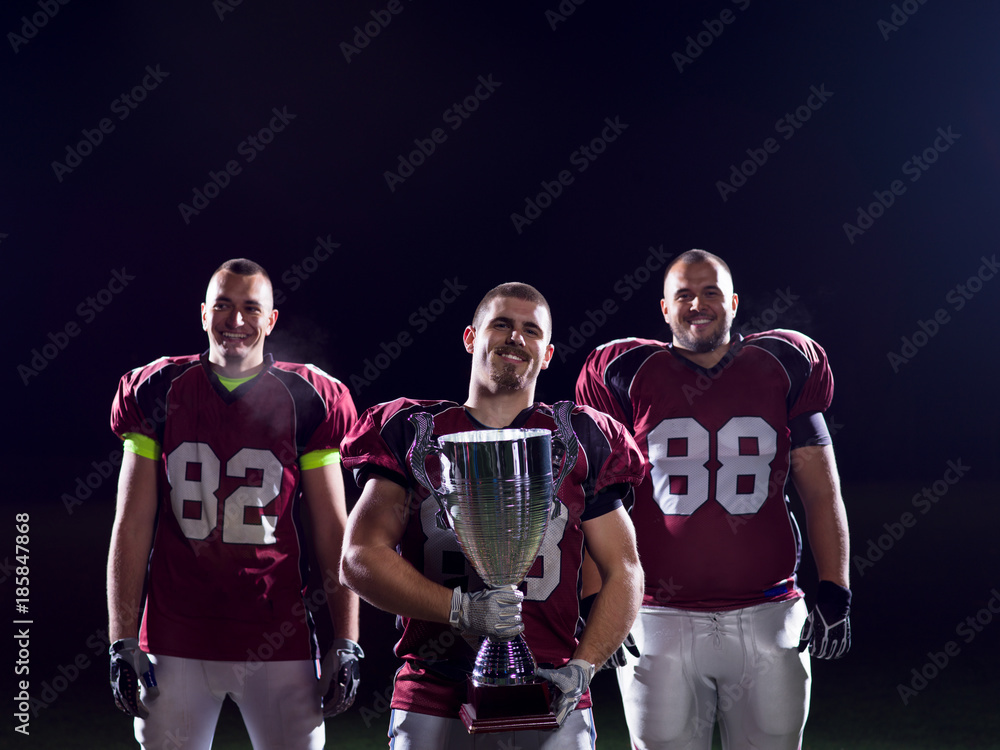 american football team with trophy celebrating victory american football team with trophy celebrating victory