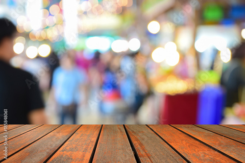 blurred image wood table on people in shopping mall with bokeh.