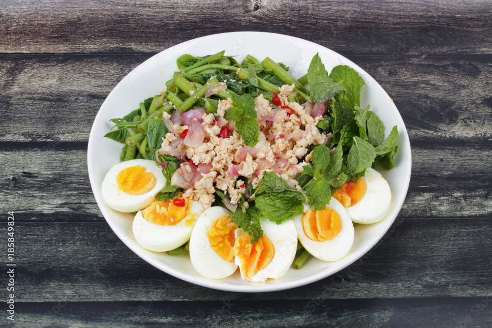 Spicy Chinese morning glory salad with boiled egg topped pork chops. Spicy Chinese morning glory salad with boiled egg topped pork chops.