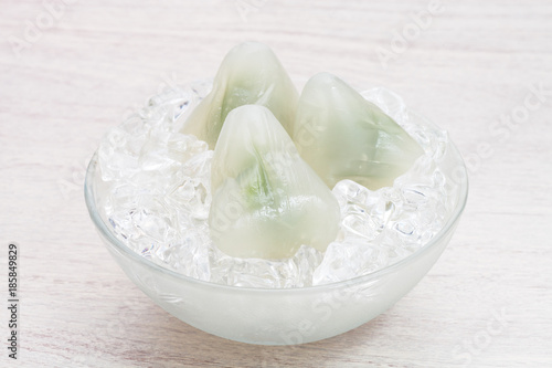 Matcha ice dumplings on ice cubes in bowl      