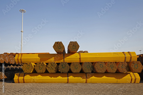Yellow stacked steel pipe