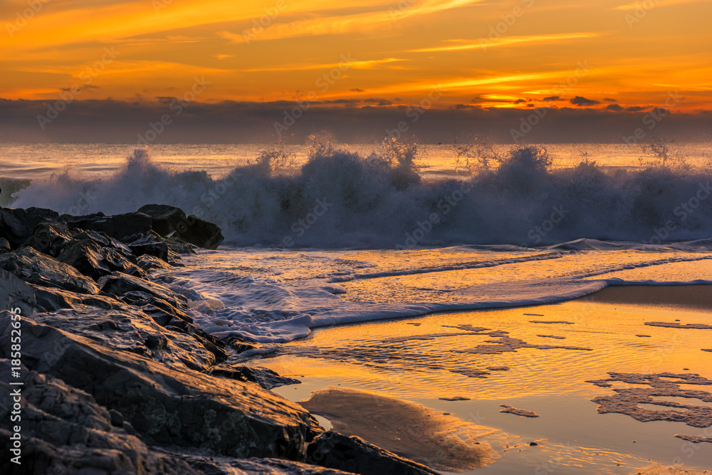 Catching the waves on New Jersey Shore. Beautiful ocean waves during sunrise at Bay Head, New Jersey