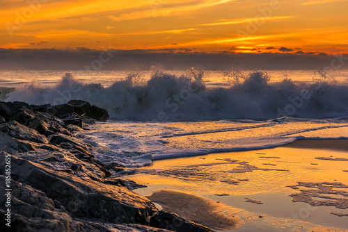 Catching the waves on New Jersey Shore. Beautiful ocean waves during sunrise at Bay Head, New Jersey