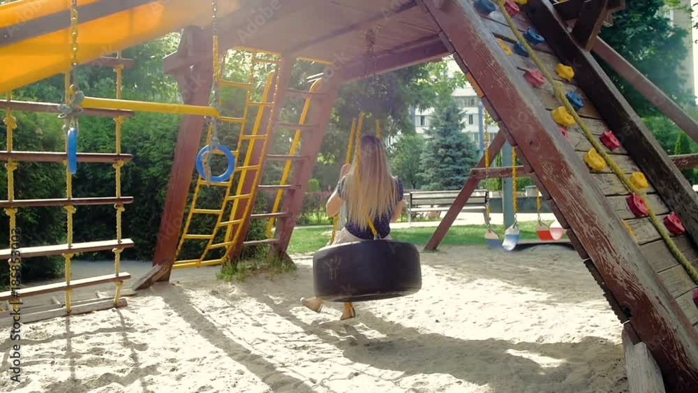 Slow motion video of happy smiling young woman having fun on playground at park Slow motion video of happy smiling young woman having fun on playground at park