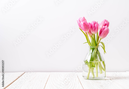 Canvas Print pink tulip flower on wood background