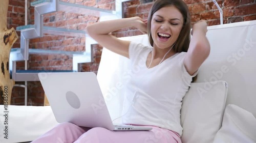 Girl, Woman Listening Music on Laptop and Dancing, Sitting on Stairs photo