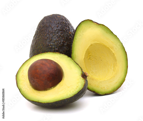 Whole and half avocado isolated on white.