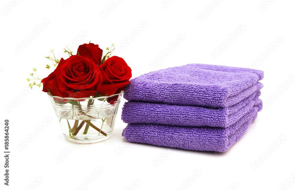 Stack of colorfull towels closeup and rose flower
