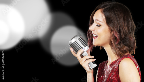 Beautiful and stylish woman singerwith a microphone