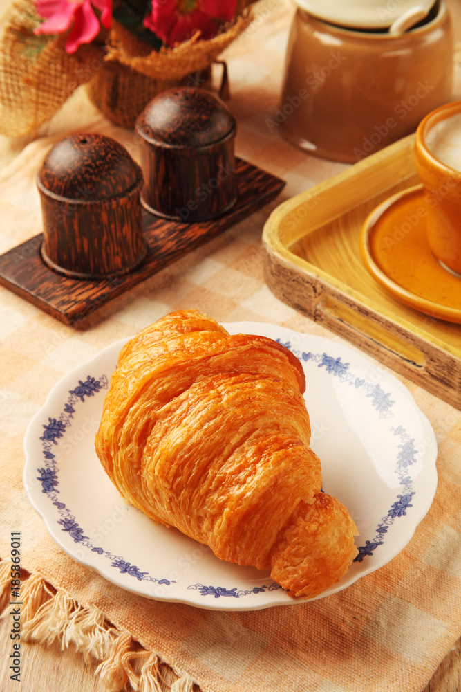  Delicious croissant on plate    