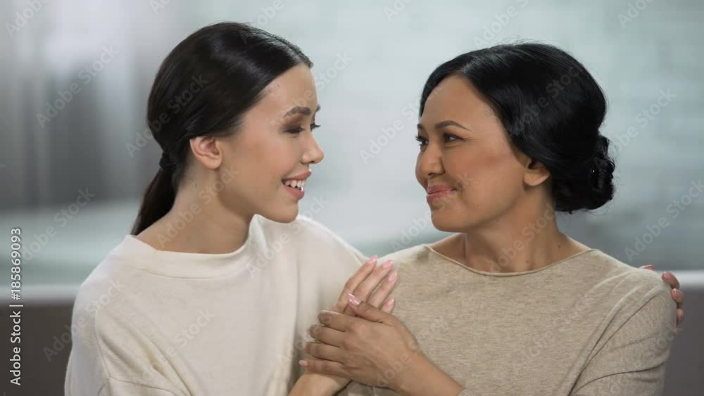 Young and adult women embracing, close relationship of mother and daughter Young and adult women embracing, close relationship of mother and daughter