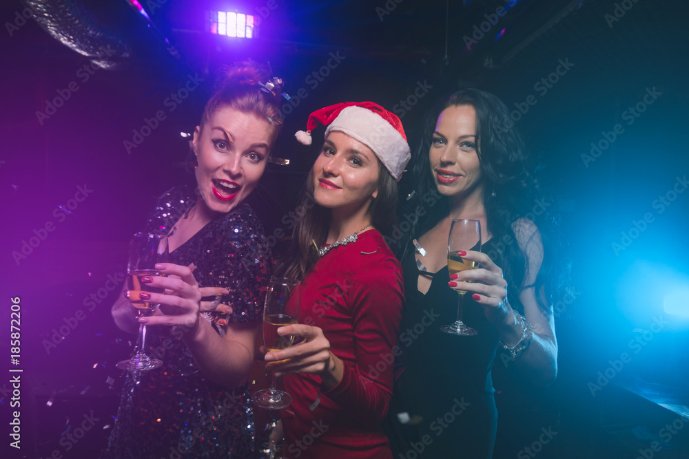 Women with glasses of champagne on new year or christmas party Women with glasses of champagne on new year or christmas party