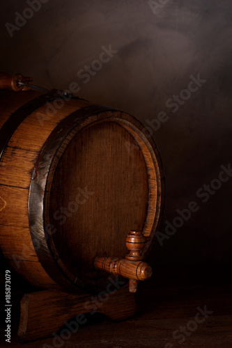 a small wooden wine bar, barrel on the legs and a wooden crane on a wooden background