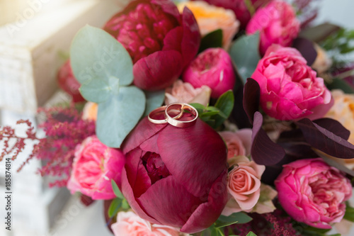 Beautiful wedding bouquet and gold rings