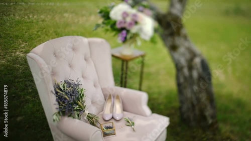 Wedding bouquet and accessories on an antique chair in the garden photo