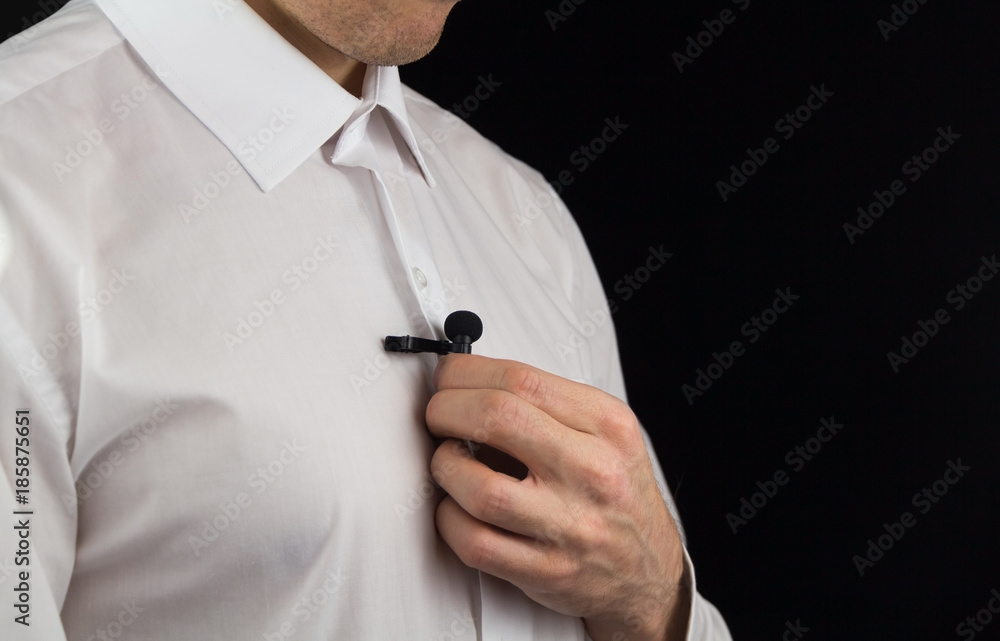 A man puts on lavalier microphone, preparation for interview A man puts on lavalier microphone, preparation for interview