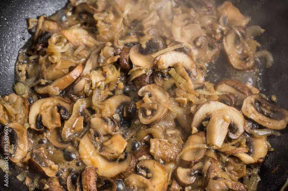 Mushrooms fried in a pan. Selective focus. Mushrooms fried in a pan. Selective focus.