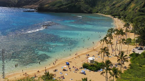 close up panning shot of the beach and reef at the popular snorkeling location, hanauma bay in hawaii photo